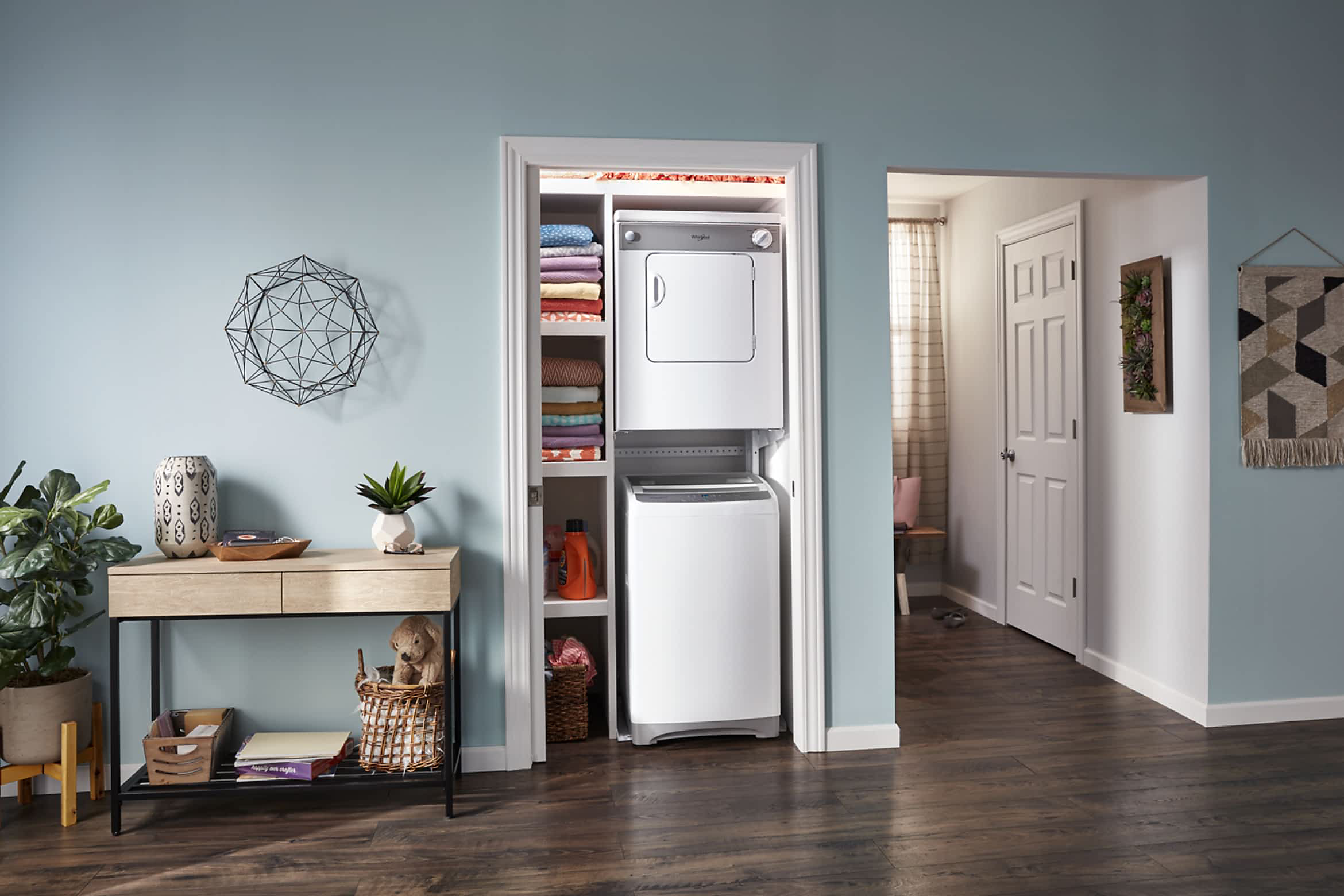 A Whirlpool® Stacked Washer & Dryer in a closet