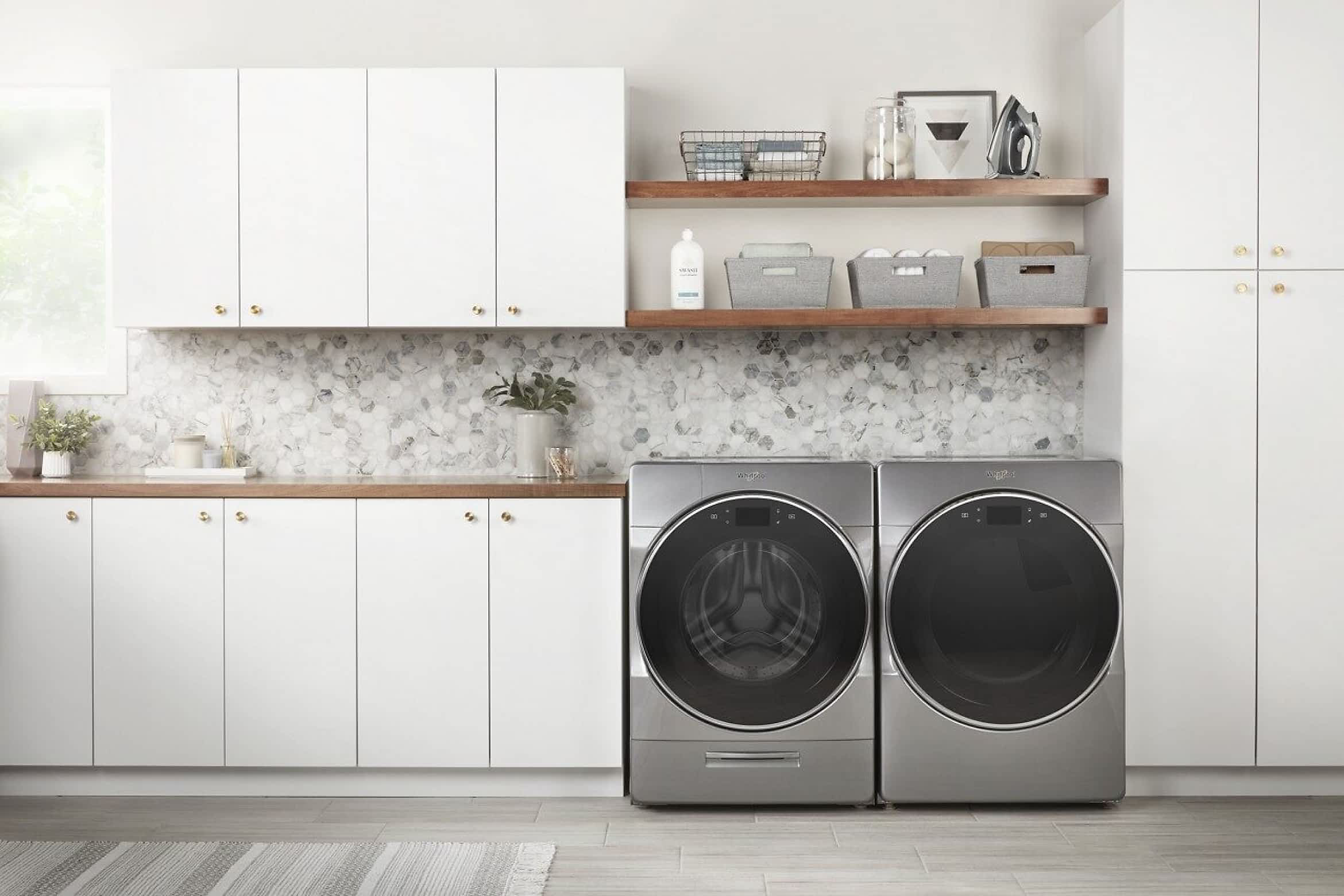 A Whirlpool® Front Load Washer & Dryer Set in a clean white laundry room