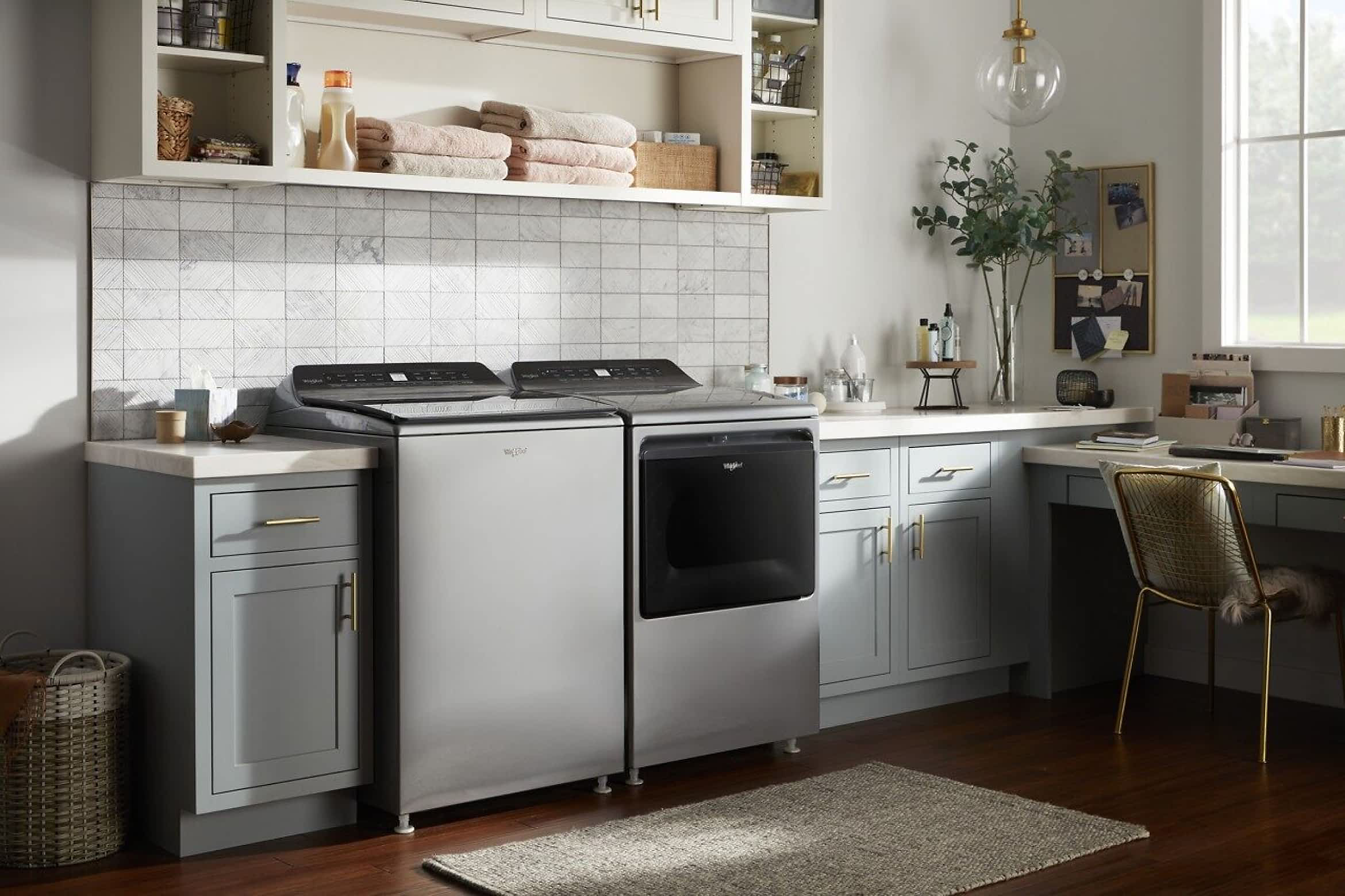 A Whirlpool® Top Load Washer & Dryer Set in a modern home