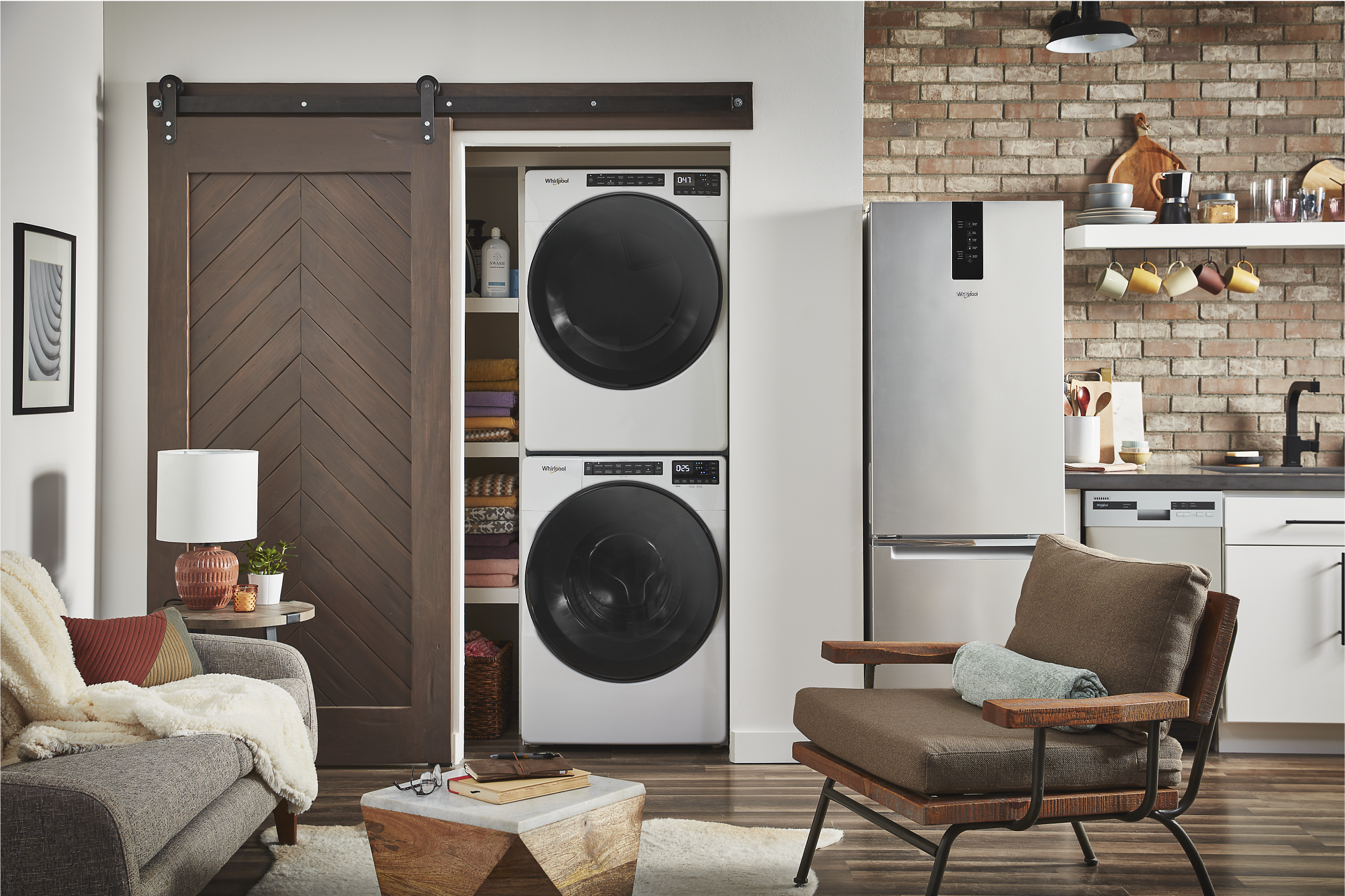 A Whirlpool® Stacked Washer & Dryer in a closet with folding doors