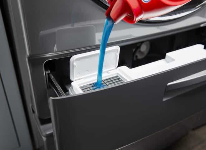 Blue laundry detergent being poured into a Load & Go™ Dispenser