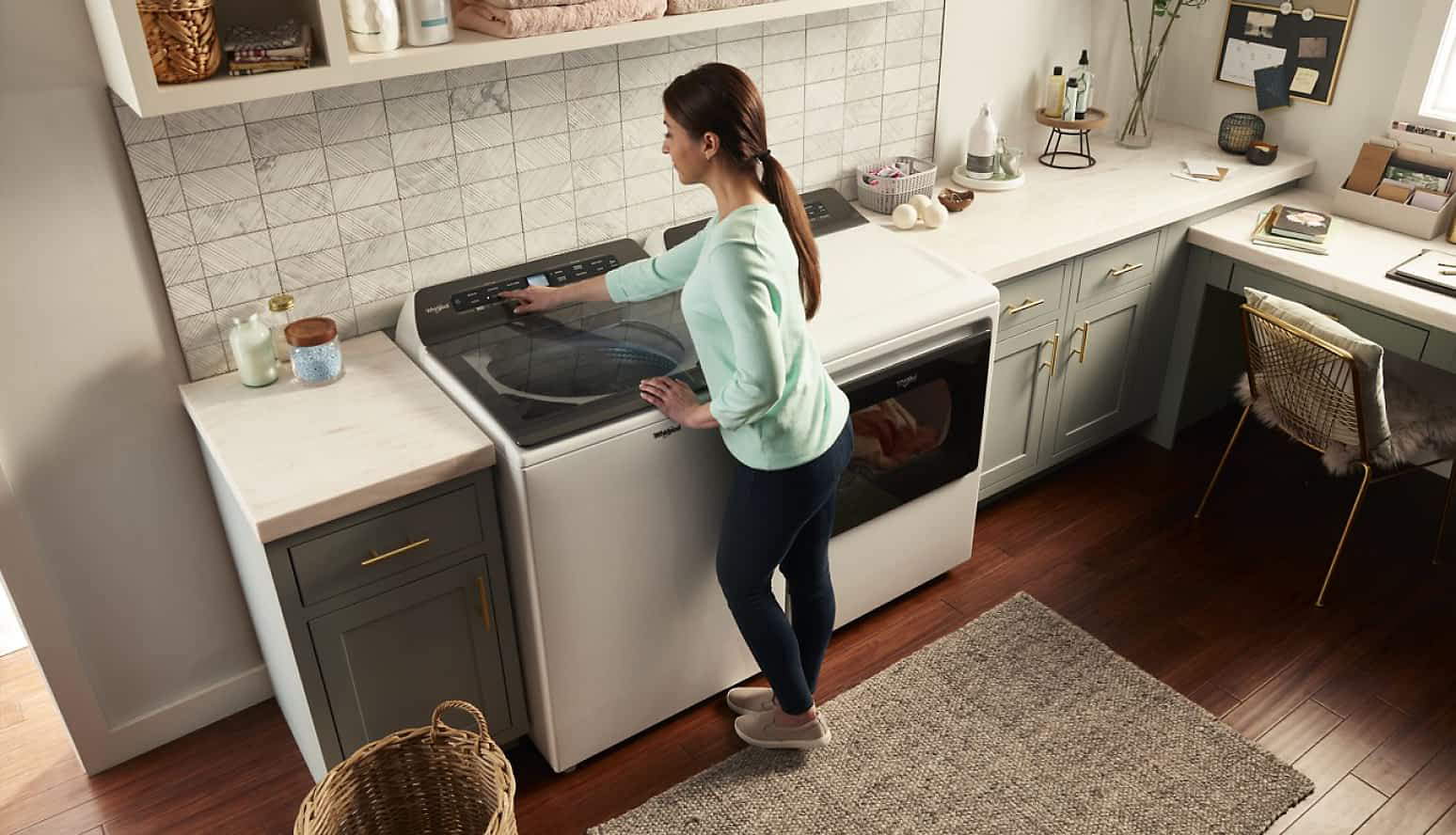 A woman using a Whirlpool® Top Load Washer
