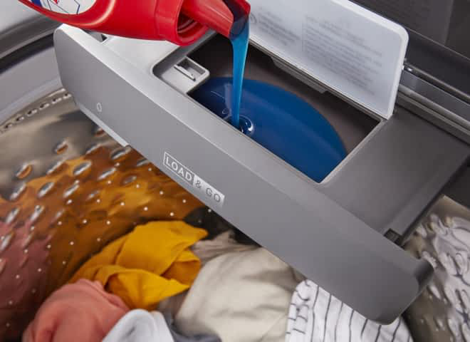 Laundry detergent being poured into a Load & Go™ Dispenser