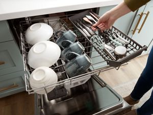 arranging dishes in dishwasher