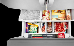 Open bottom freezer drawer with food and ice. Open bottom freezer drawer with food and ice.