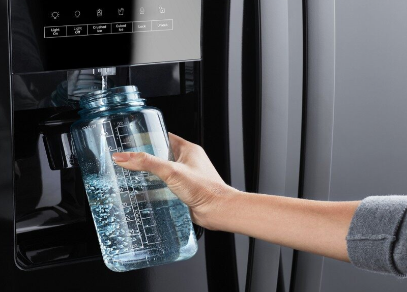 A person refilling a reusable water bottle.