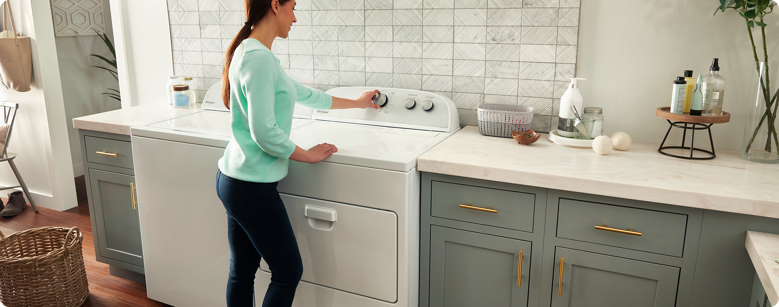 Woman starting her Whirlpool® dryer.