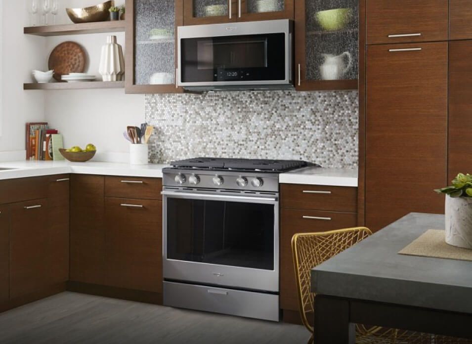 A kitchen with a Whirlpool® range and microwave