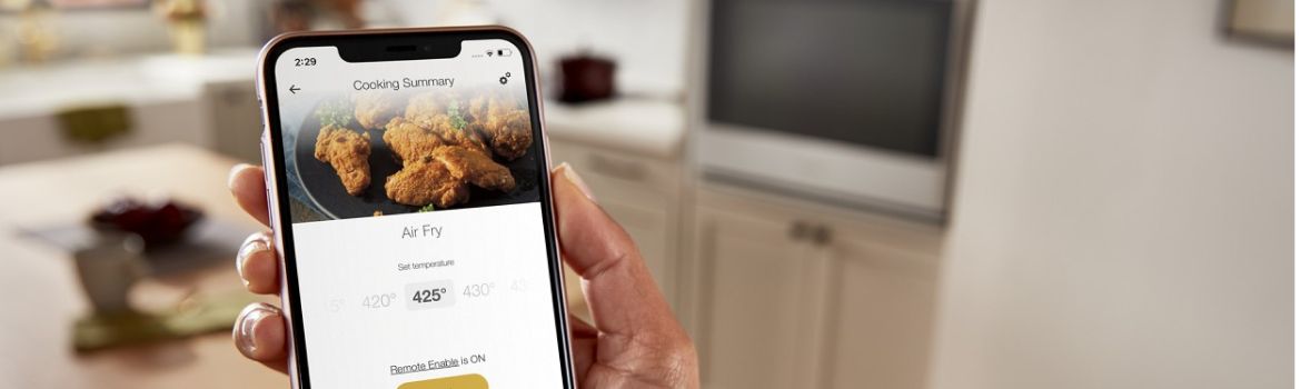 A hand using the Whirlpool® App on a smartphone.