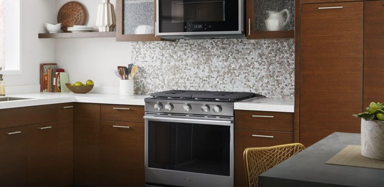 A kitchen with a Whirlpool® range and microwave