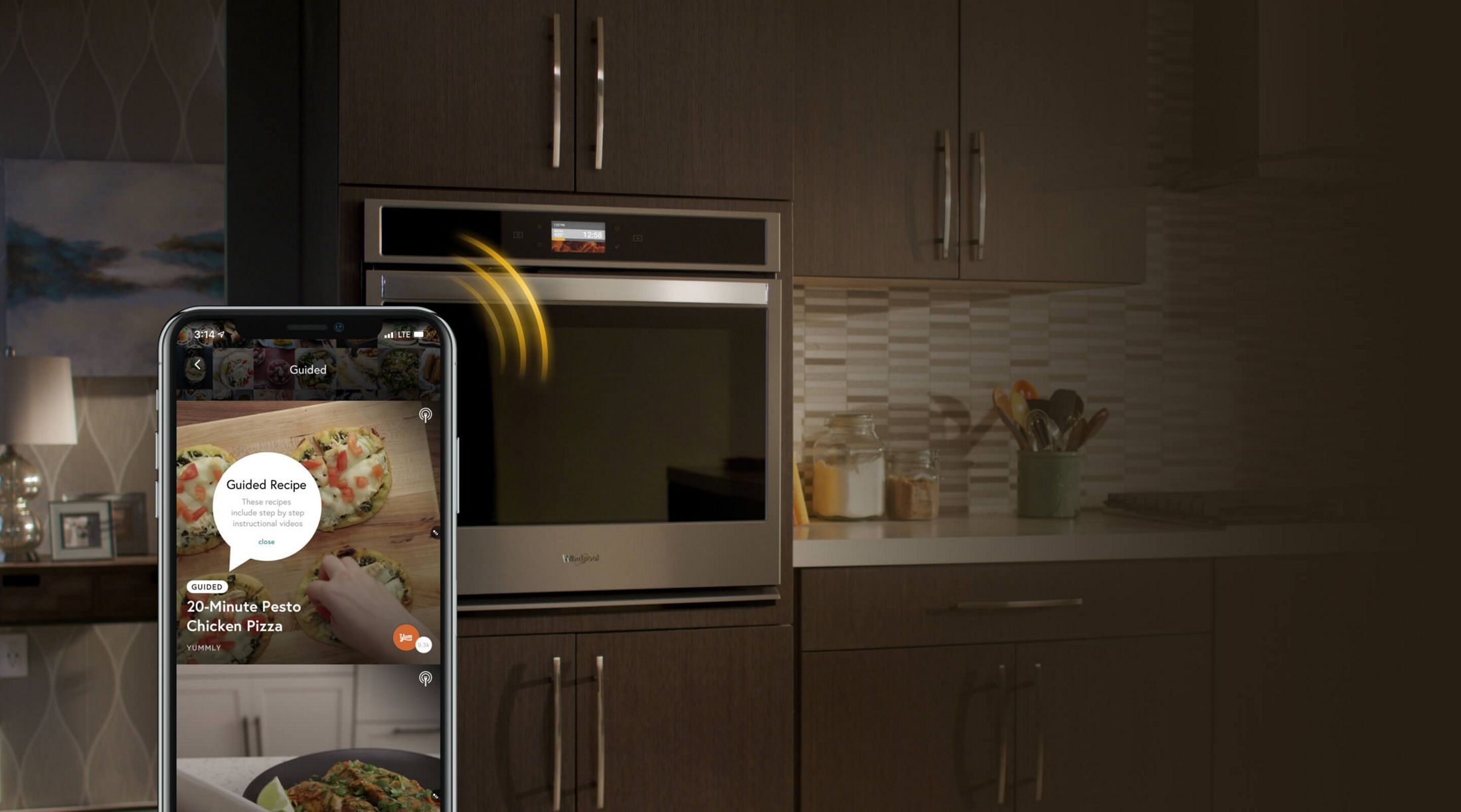 Smartphone sending cooking instructions from the Yummly® app to a Whirlpool® smart wall oven