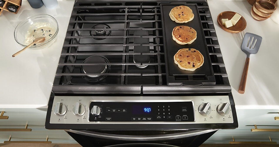 A gas stove with pancakes.
