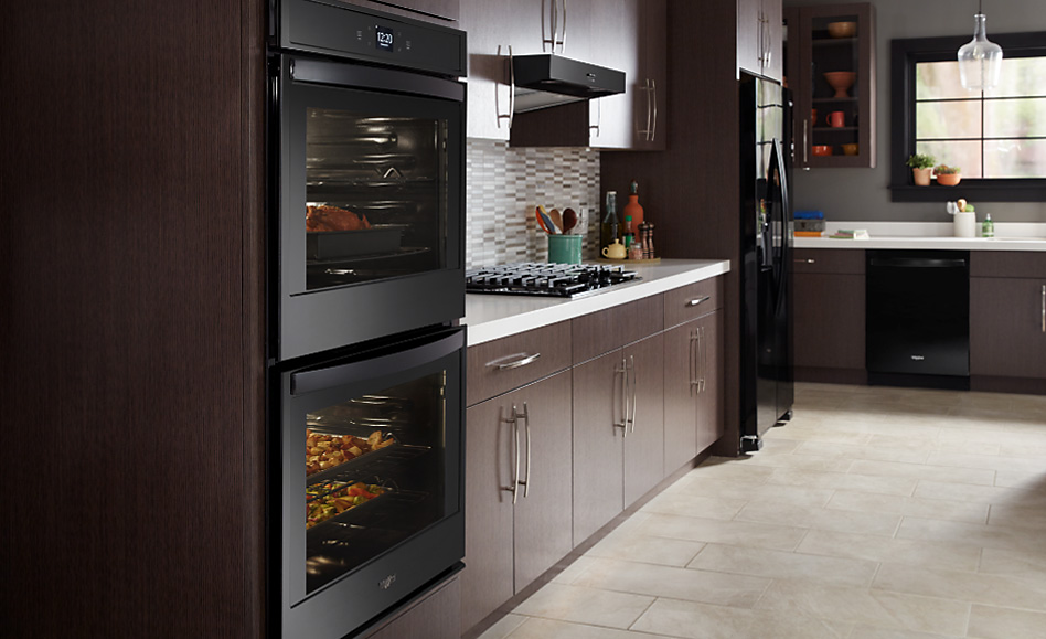 A kitchen featuring various black Whirlpool appliances