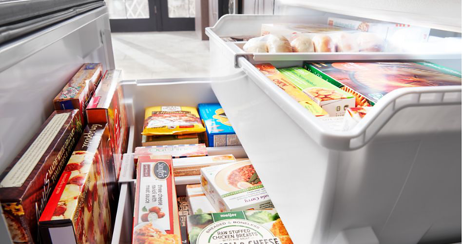 A freezer containing a variety of frozen food items arranged on two levels