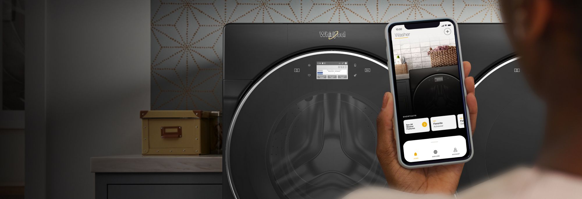 Smartphone with My Home screen in the Whirlpool® app in front of laundry pair