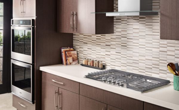 Gas cooktop built into a white countertop