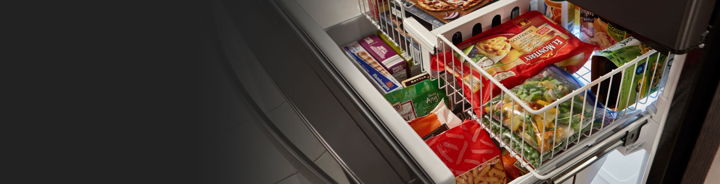 A multi-shelved freezer with food in it.