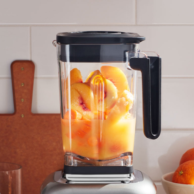 Halved peaches in a blender