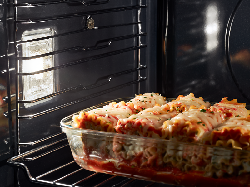 Lasagna cooking in an oven