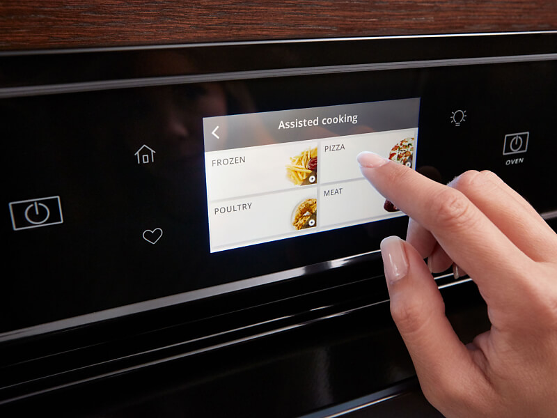 Person touching a Whirlpool® oven touchscreen control panel