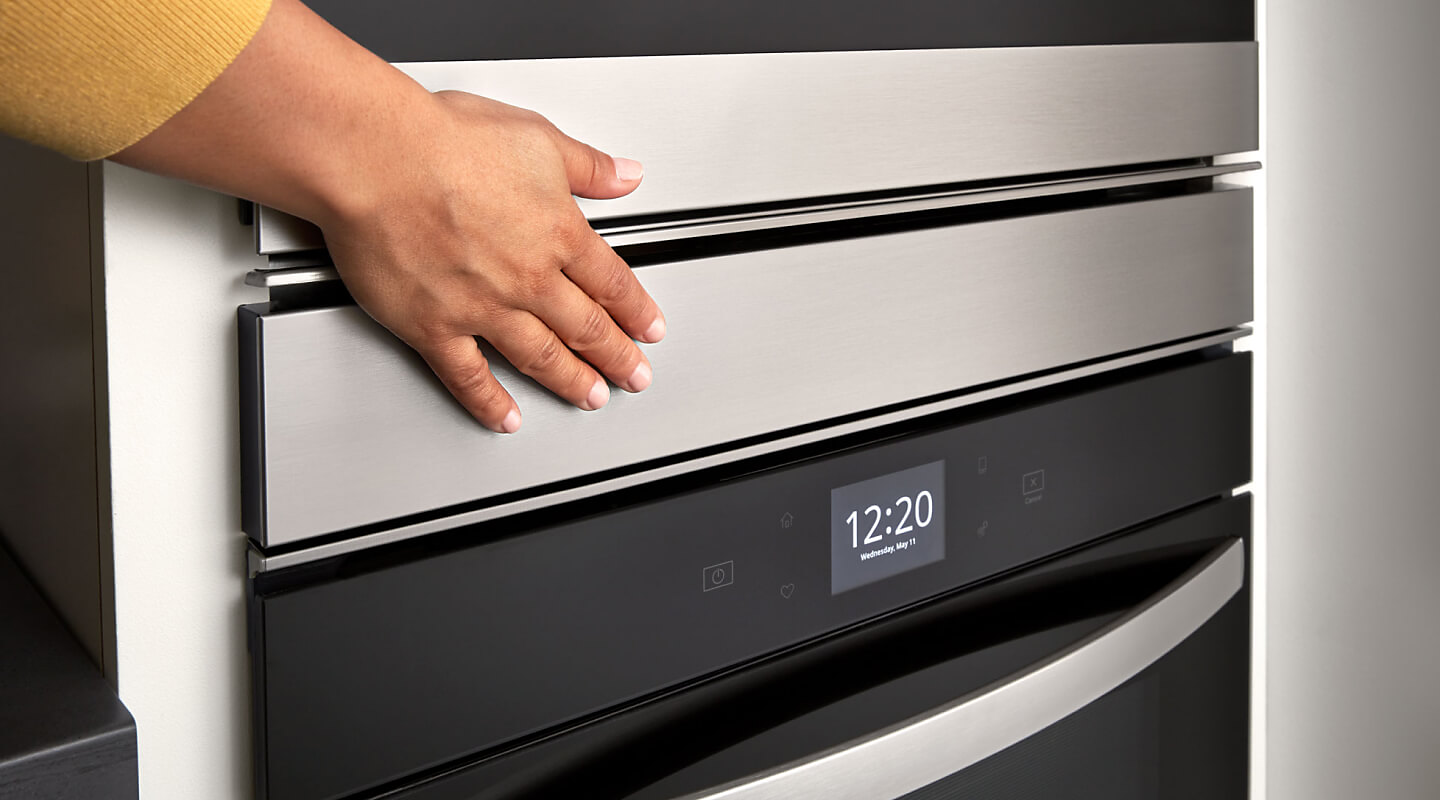 Hand touching a Whirlpool® double wall oven
