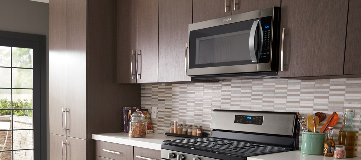  Whirlpool® Over-the-Range Microwave in brown cabinetry