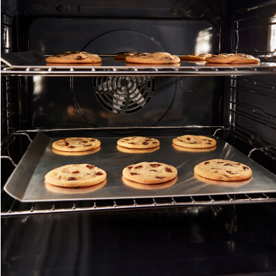 Cookies on baking sheets inside oven