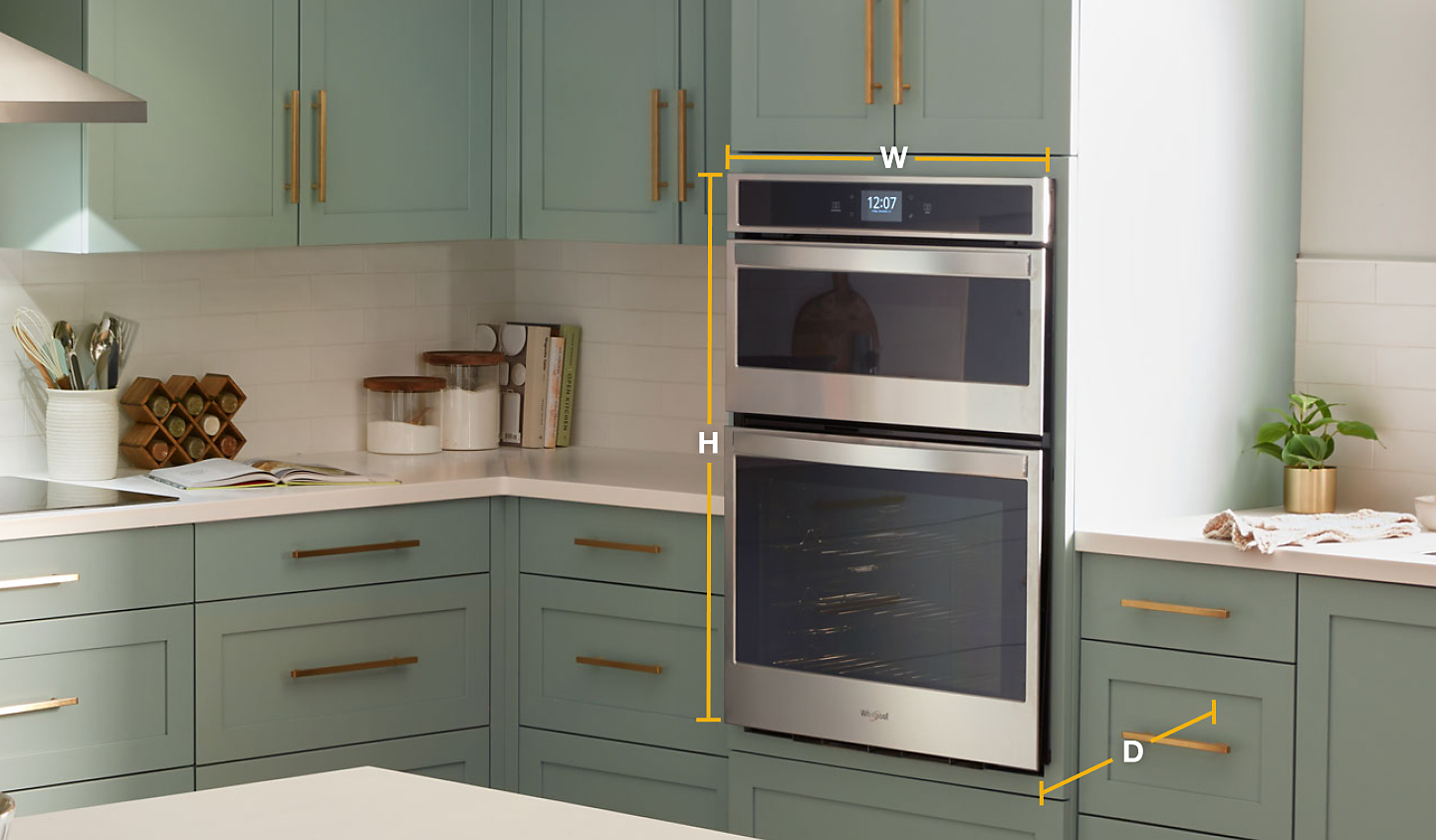Whirlpool® stainless steel combination wall oven set into light green cabinets with diagram of width, height and depth 
