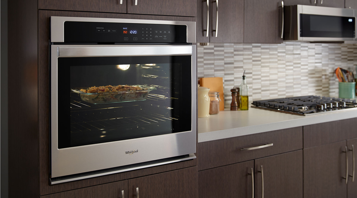 5.0 Cu. Ft. Whirlpool® single wall oven built into wood finished cabinets. 