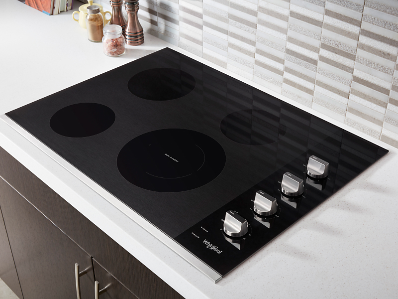 A black Whirlpool® cooktop