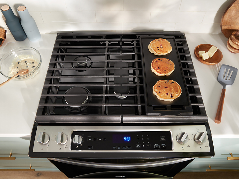 Pancakes cooking on a stovetop griddle