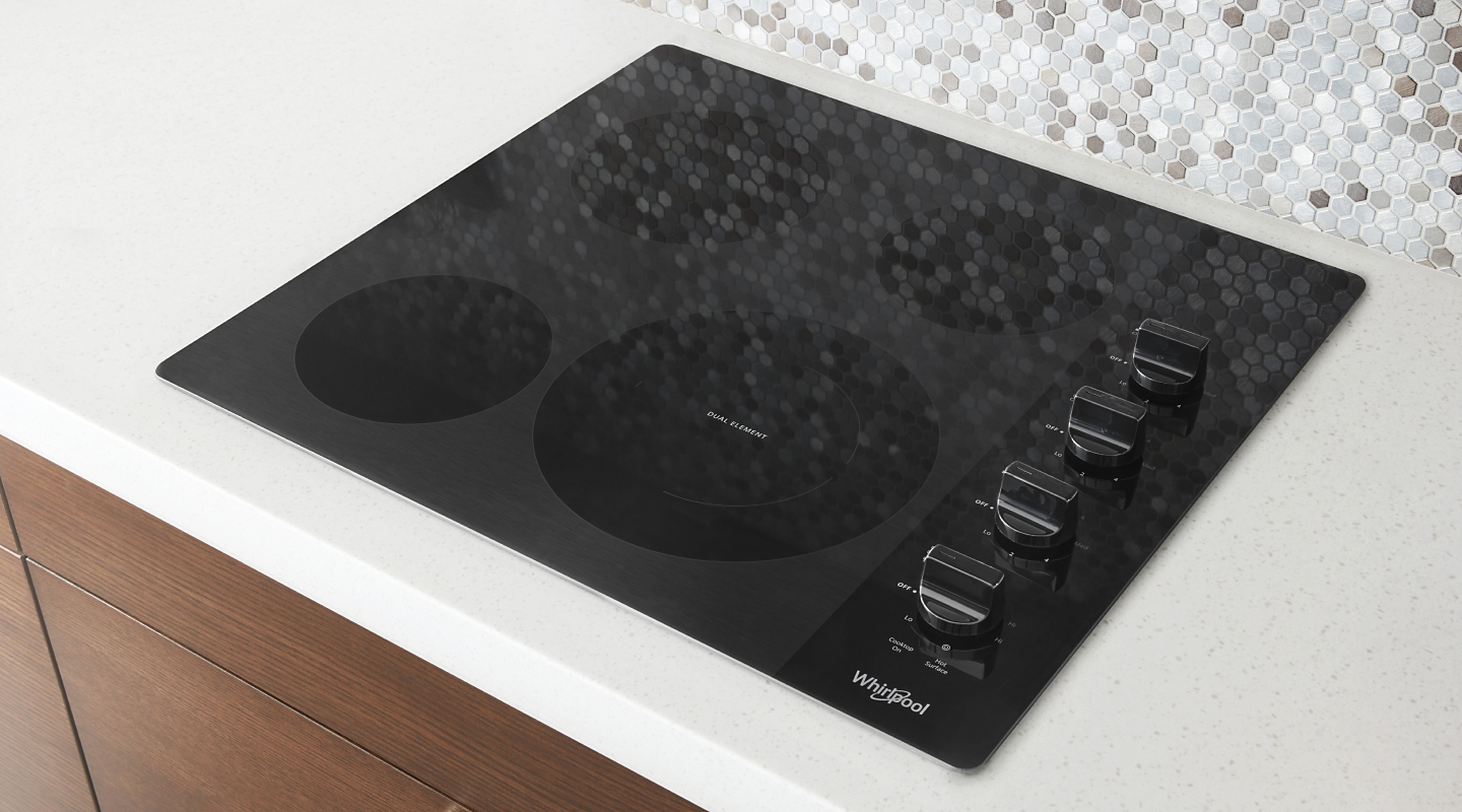 Top view of Whirlpool® cooktop set into white countertop