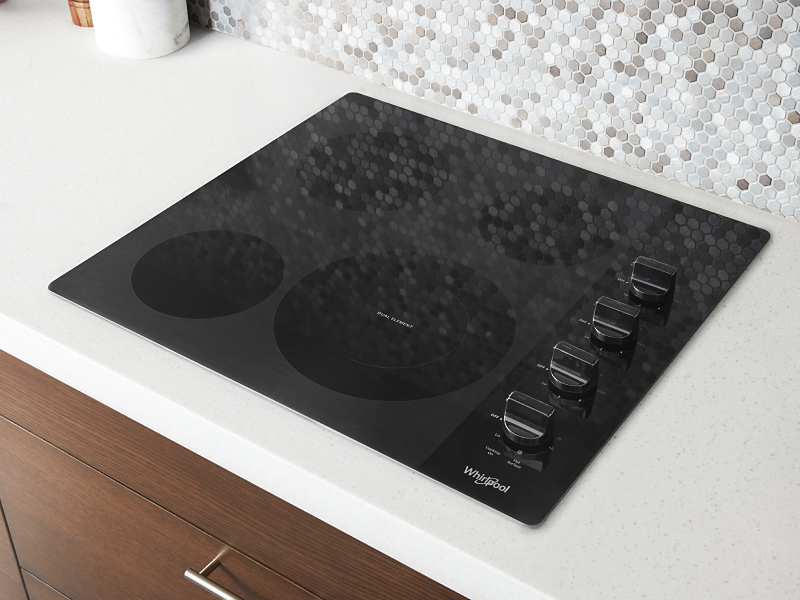 Top view of Whirlpool® cooktop set into white countertop