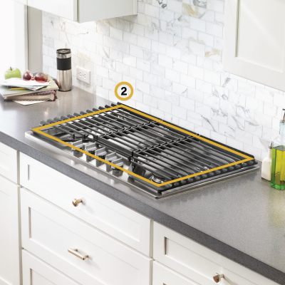 Gas cooktop set into gray countertop with perimeter noted to measure cooktop cutout space