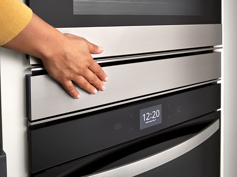 Hand touching a Whirlpool® double wall oven