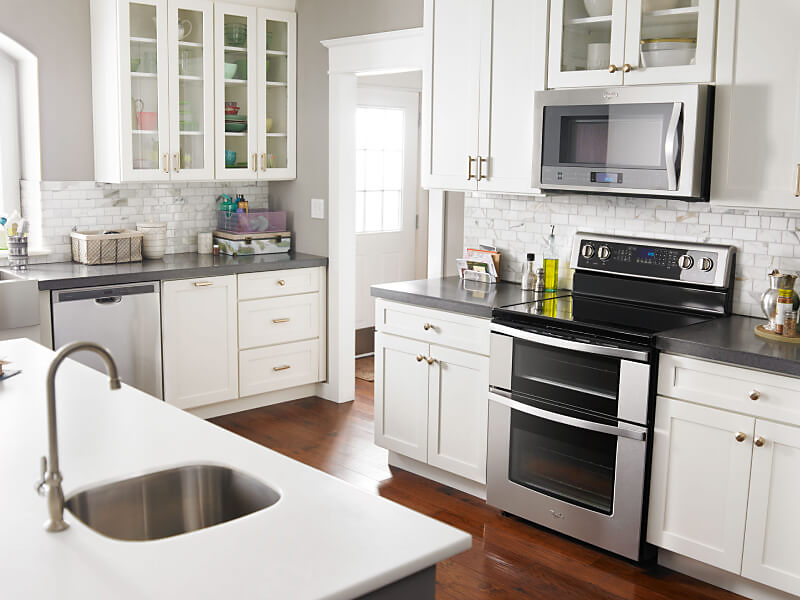 Stainless steel Whirlpool® double oven range inside a bright kitchen