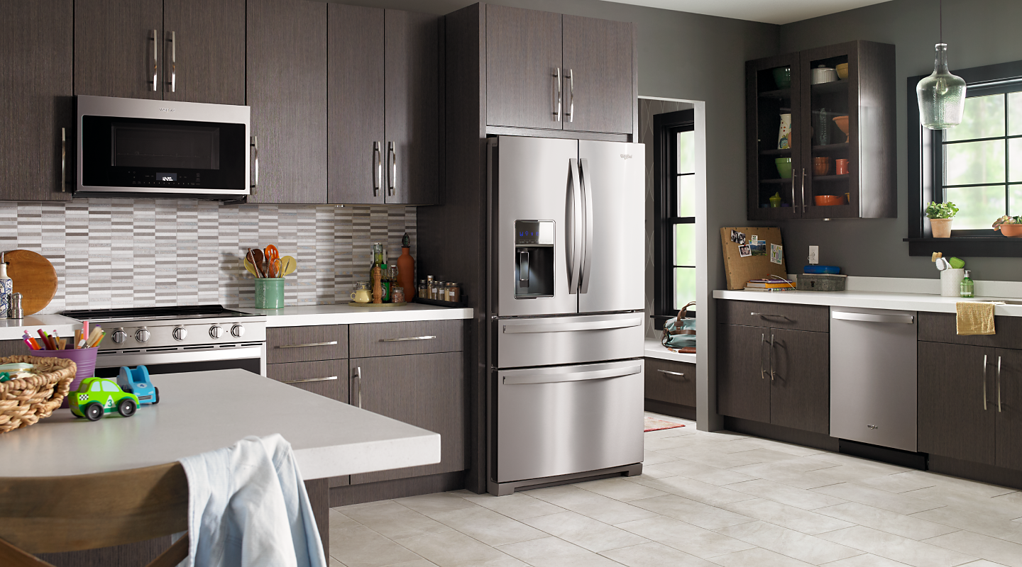 Kitchen with stainless steel appliances in brown cabinetry