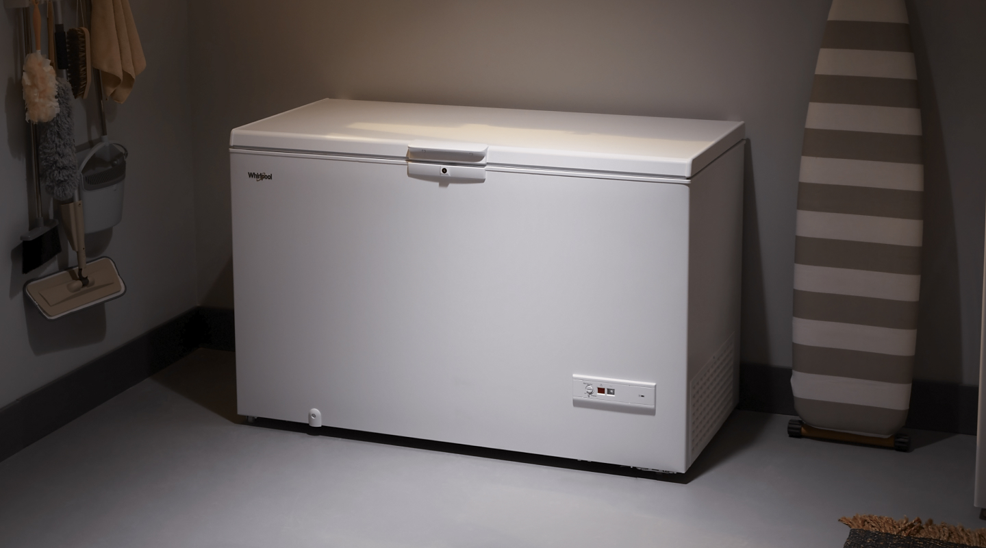 A closed white chest freezer