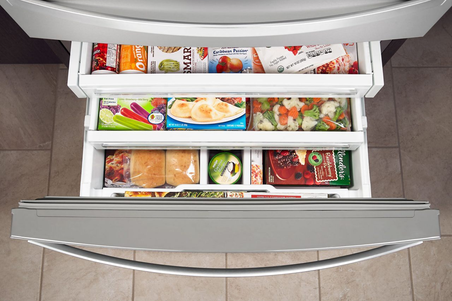 Birds-eye view of tiered shelving holding frozen goods in a bottom freezer 
