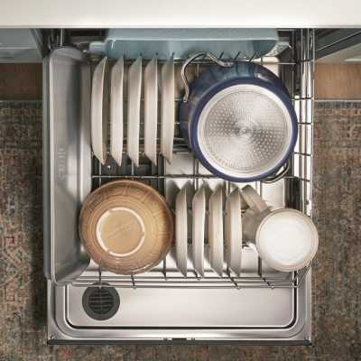 An overhead view of the bottom rack of a Whirlpool® dishwasher with dishware.