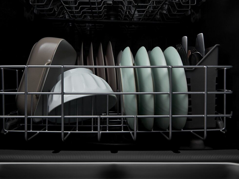 A closeup of the bottom rack of a Whirlpool® dishwasher with clean dishware.