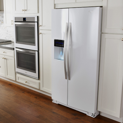 White side-by-side refrigerator in white cabinetry