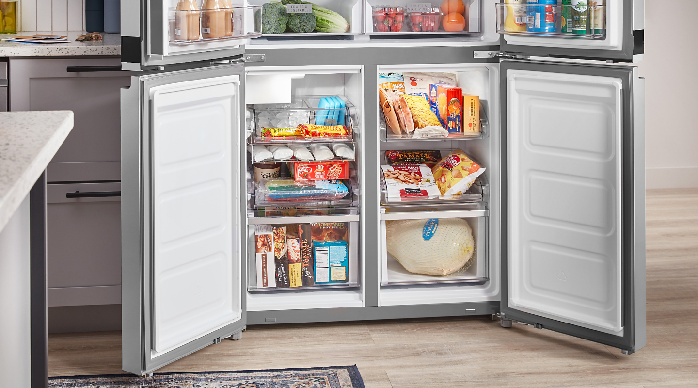 Freezer compartments of a four-door refrigerator full of food