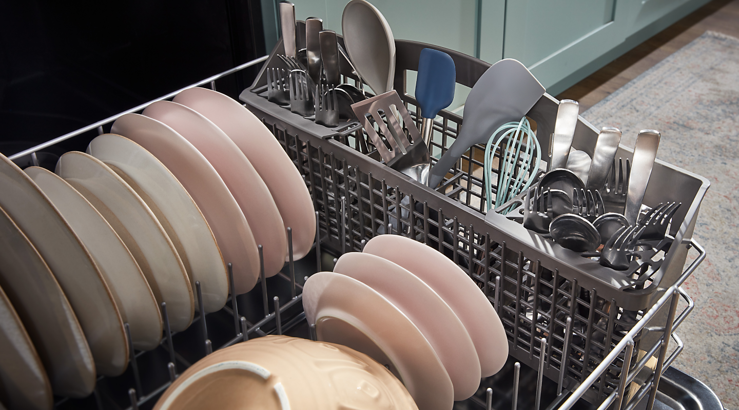 The bottom rack of a Whirlpool® dishwasher filled with dishes.
