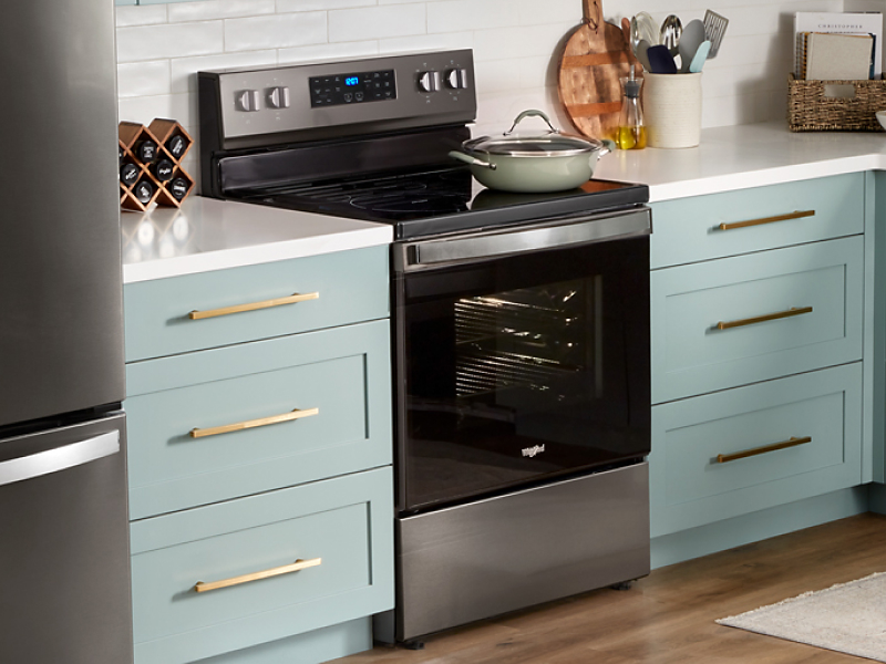 A pot sits on top of a Whirlpool® Oven 