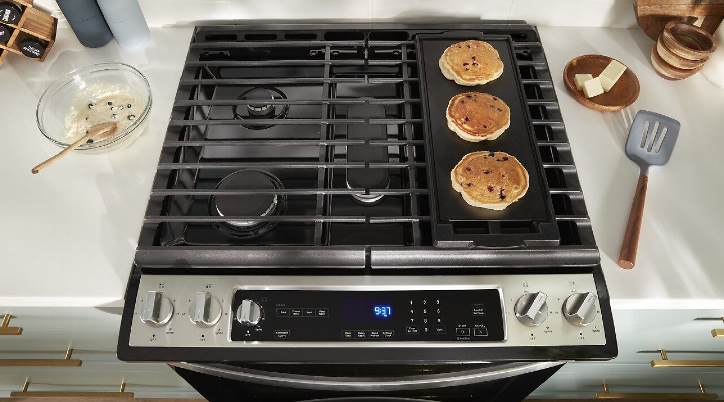 Pancakes cooking on a gas cooktop