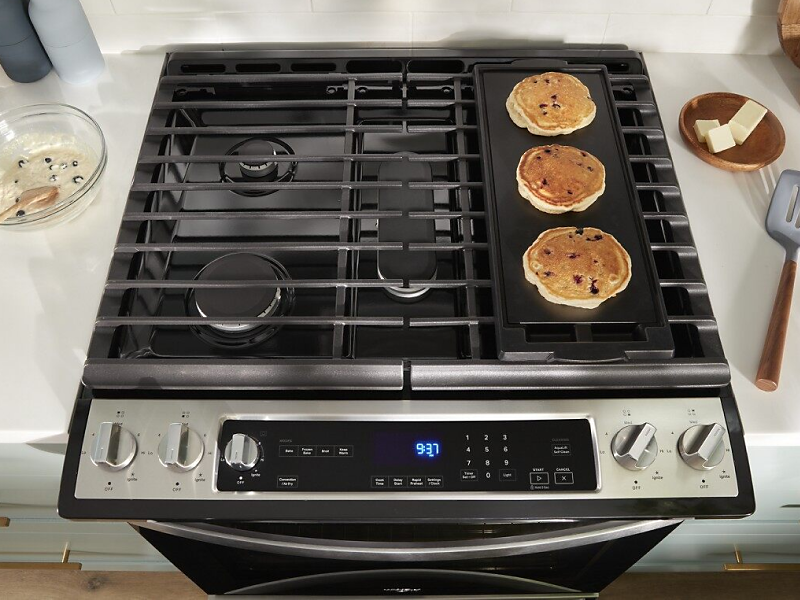 Pancakes cooking on a gas cooktop