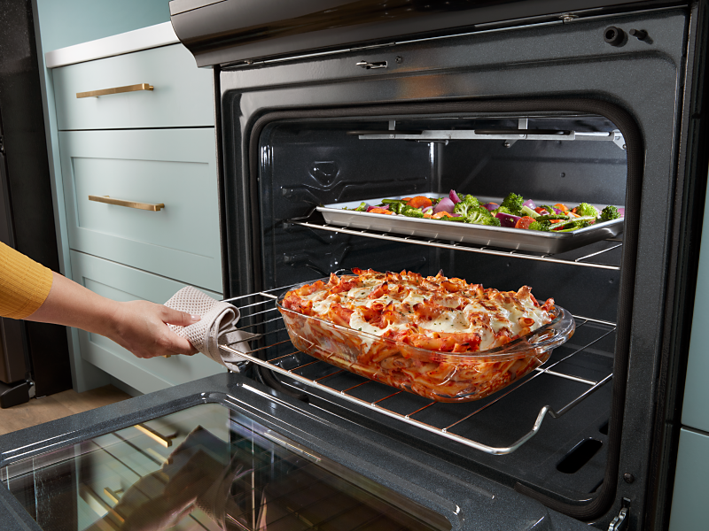Baked pasta and roasted vegetables inside a Whirlpool® oven