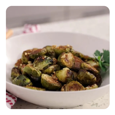 Glazed brussels sprouts in a white bowl