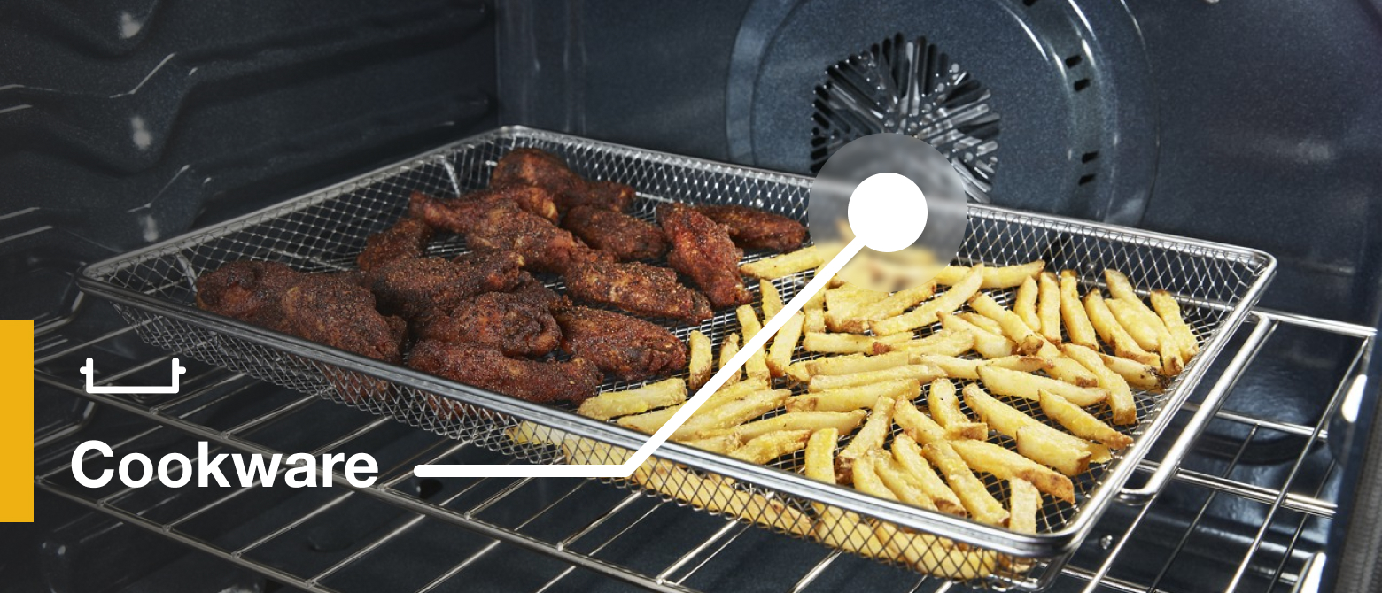 Wings and fries air frying in an oven in an air fry basket